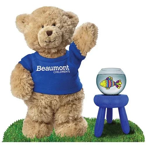 A stuffed bear wearing a blue t-shirt for Beaumont Children's.