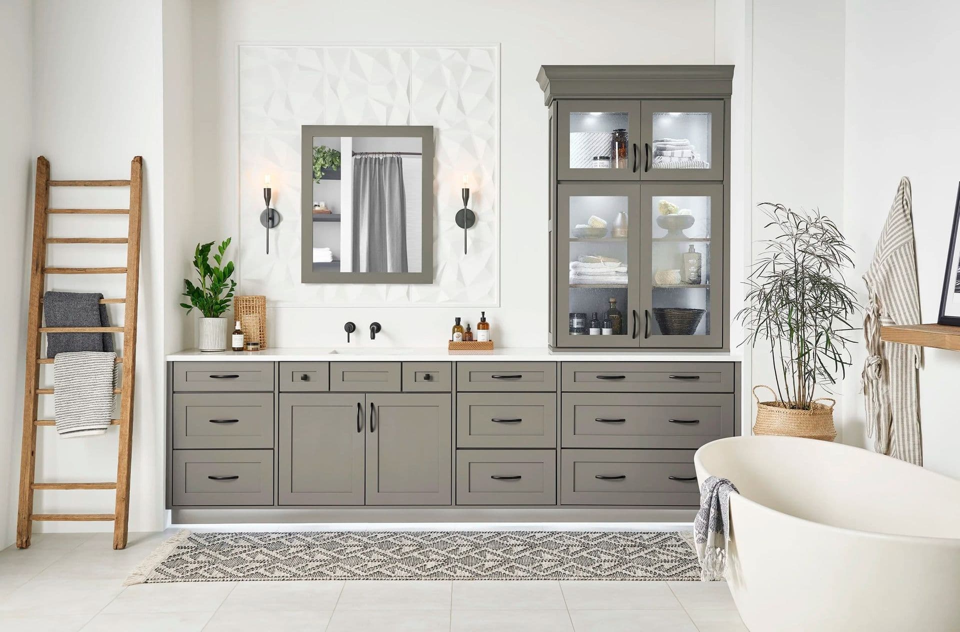 Bathroom Remodeling Design Inspiration Gallery. A bathroom with dark gray cabinets, matte black fixtures, and a large soaking bathtub to the right,