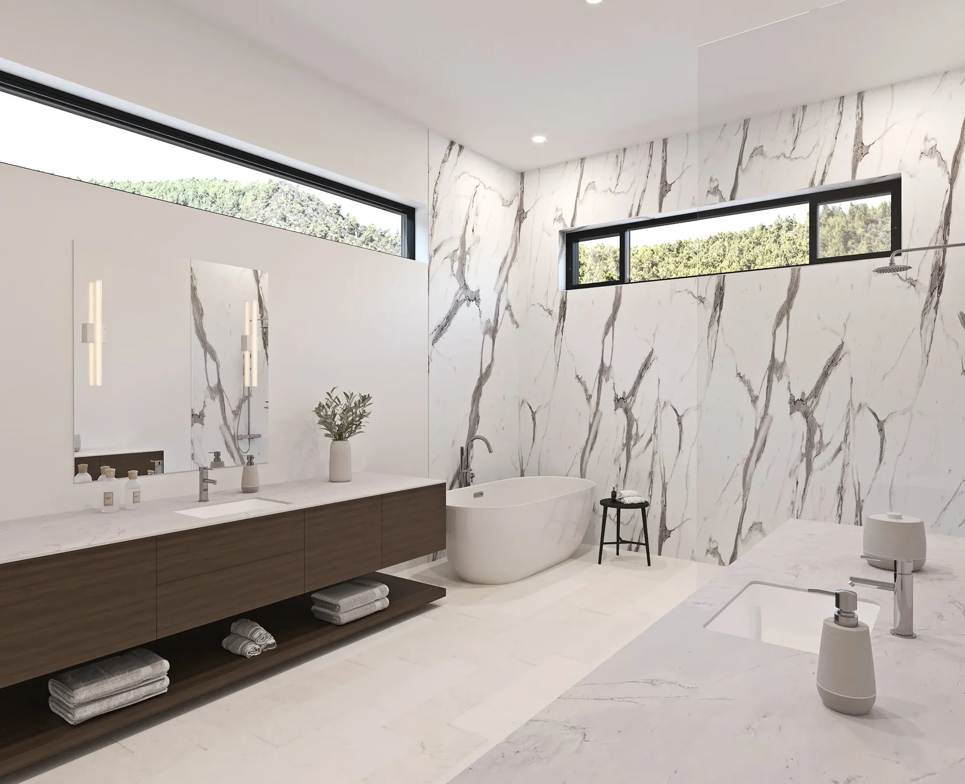 A bathroom with white and gray marble patterned walls, long narrow windows, large white soaking tub, and walk-in shower with glass partition wall.