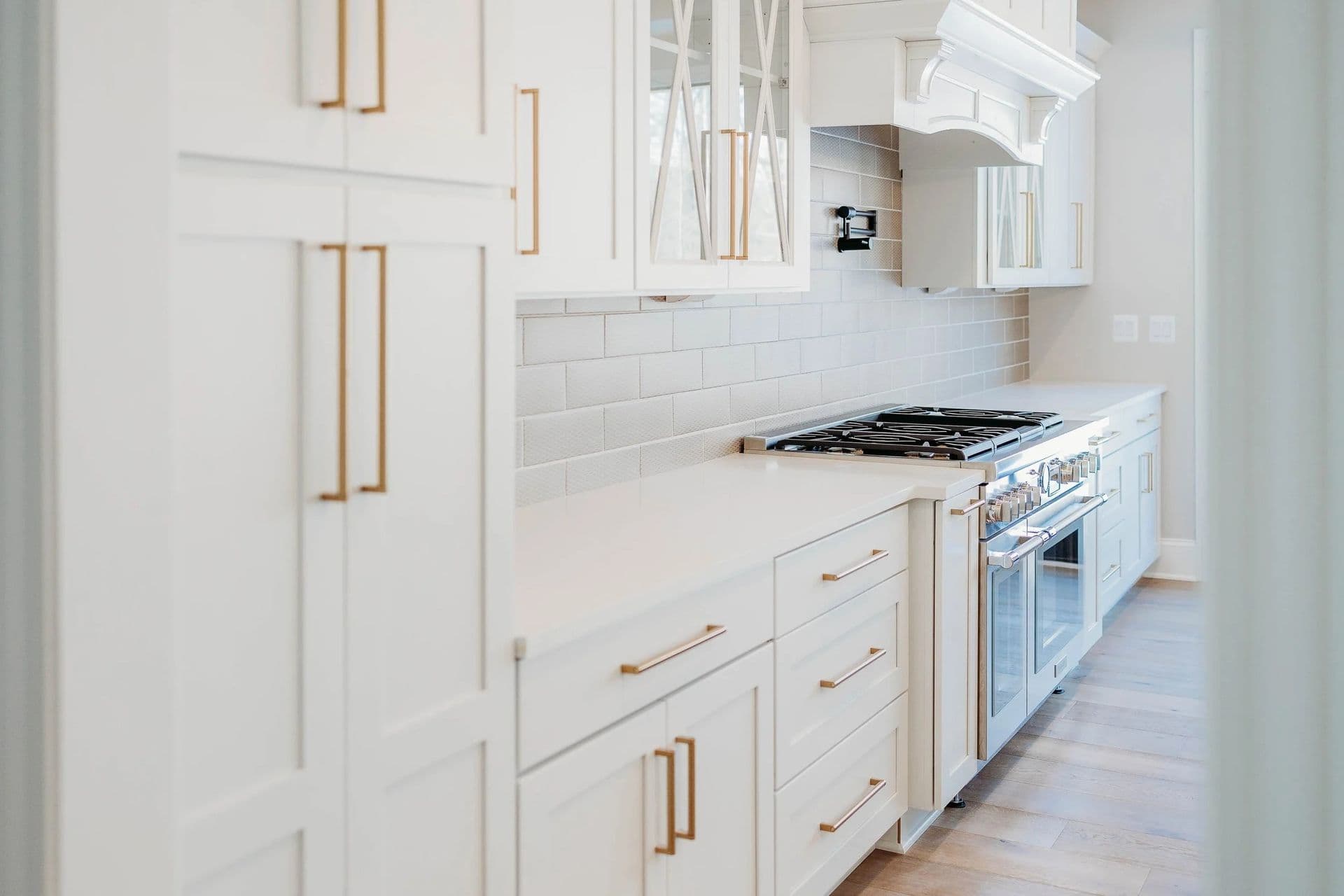Kitchen Remodeling Design Inspiration Gallery. White cabinets with gold fixtures and white countertops.