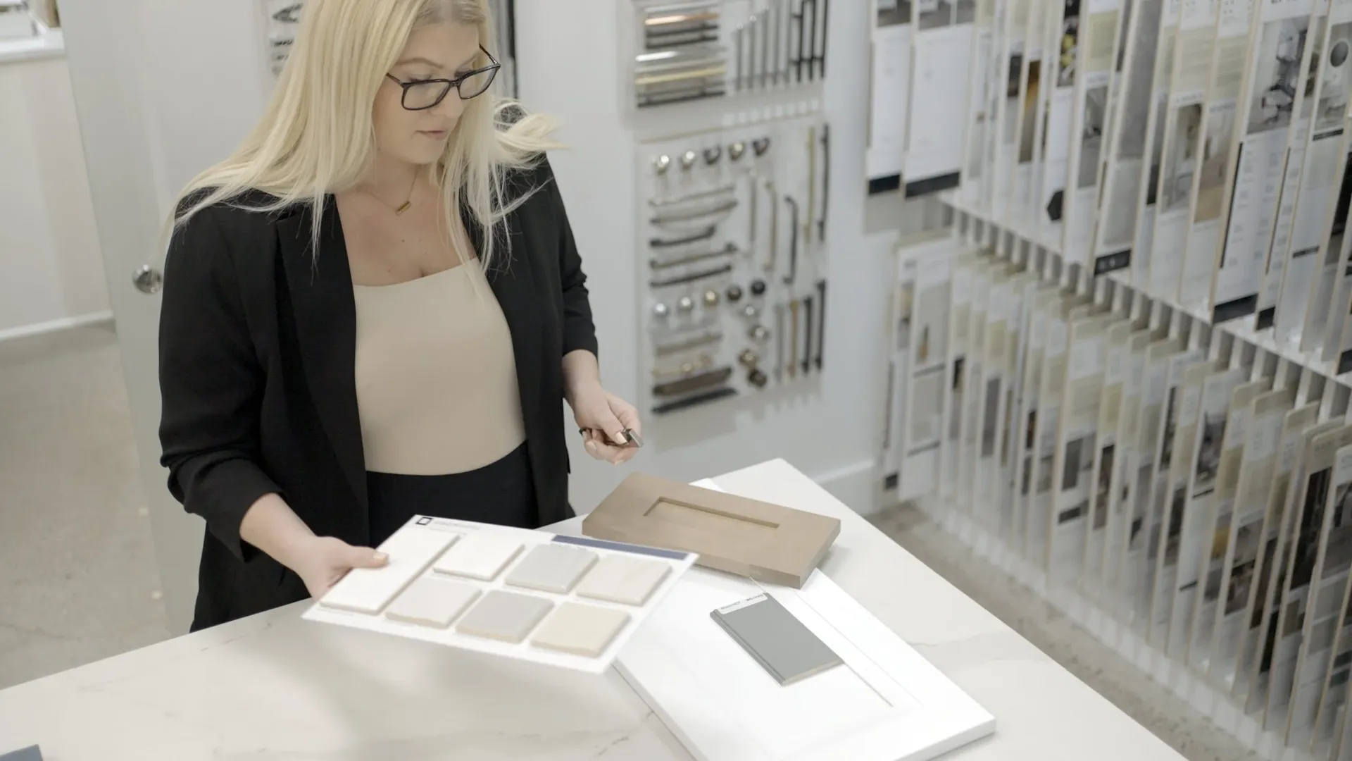 An employee lays out design swatches in a showroom.